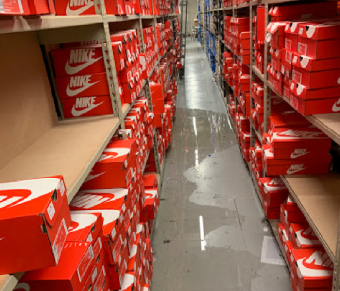 Shoe boxes in warehouse, water on floor